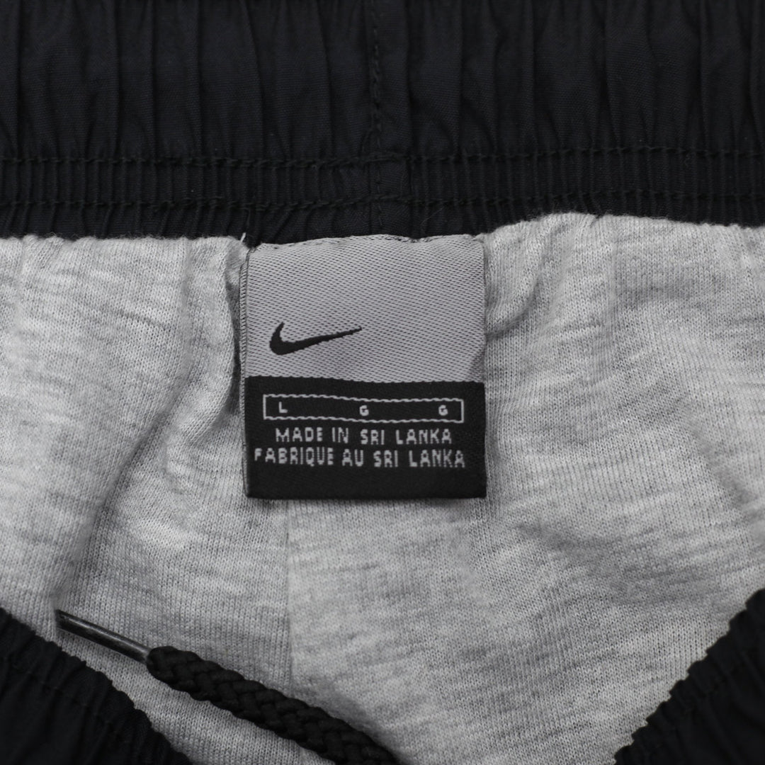 Vintage Mens 00s Nike Navy Nylon Track Pants Size L | Migration_Pants - Back View | Fashion Rerun