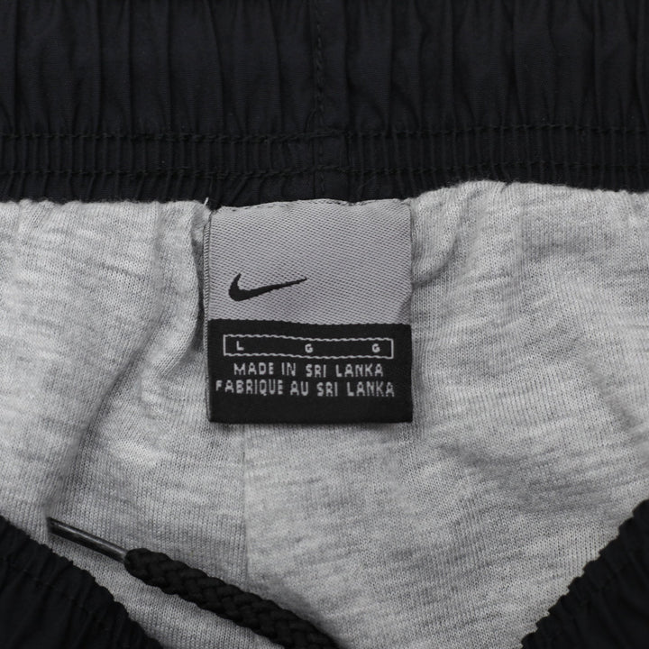 Vintage Mens 00s Nike Navy Nylon Track Pants Size L | Migration_Pants - Back View | Fashion Rerun