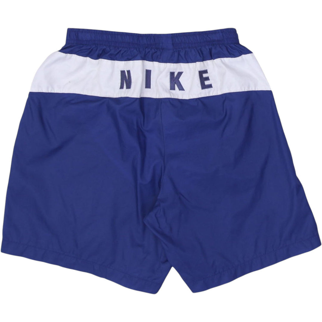 Vintage men’s Nike navy blue sports shorts with spellout logo